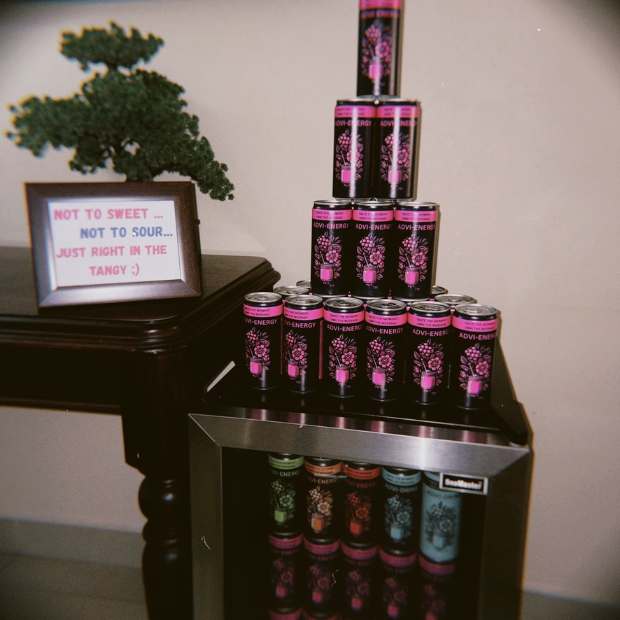ADVI-ENERGY Tangy Raspberry cans stacked in a display pyramid